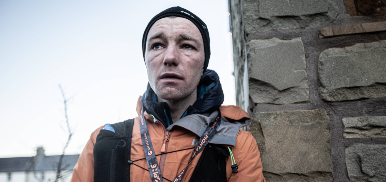The exhaustion and emotion hits Jack Scott at the finish of his record-breaking Winter Spine Race run in 2024. Photo by Adam Jacobs for Spine Race.