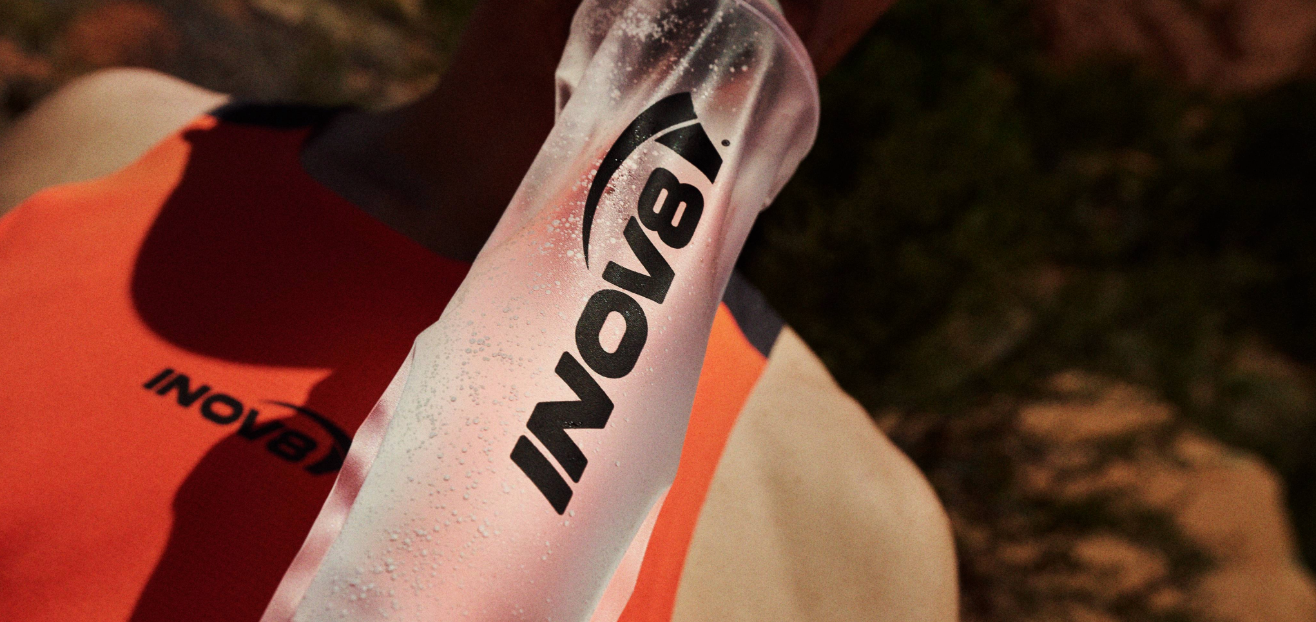 Athlete drinking out of a soft flask in the hot sun
