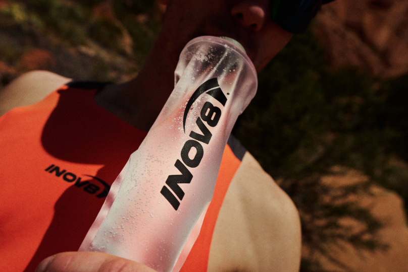 Athlete drinking out of a soft flask in the hot sun
