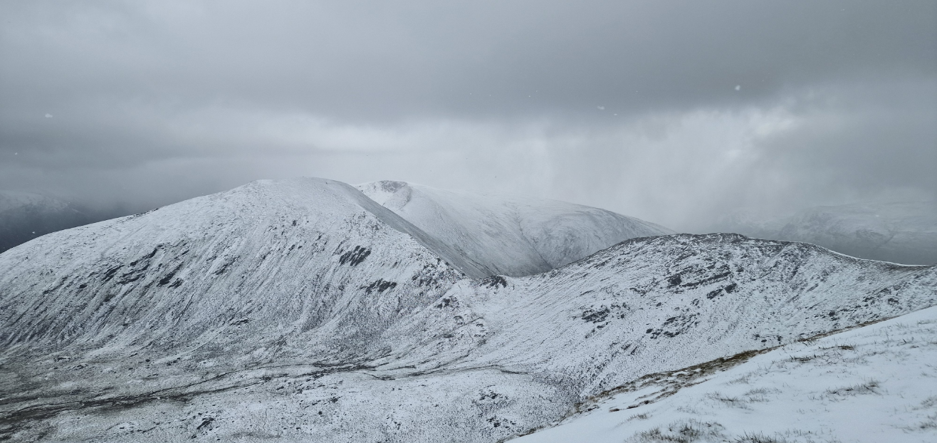 Snowy landscape with a dark snowstorm in the background