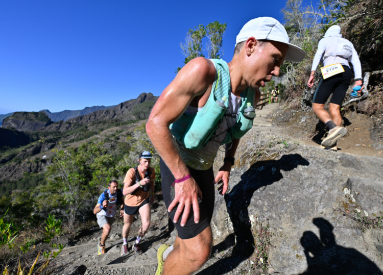 INOV8 Athlete Yannick Noel climbing a steep, rocky trail in Reunion