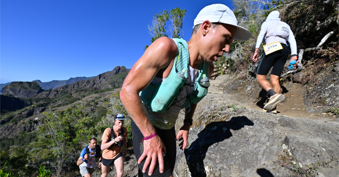 INOV8 Athlete Yannick Noel climbing a steep, rocky trail in Reunion