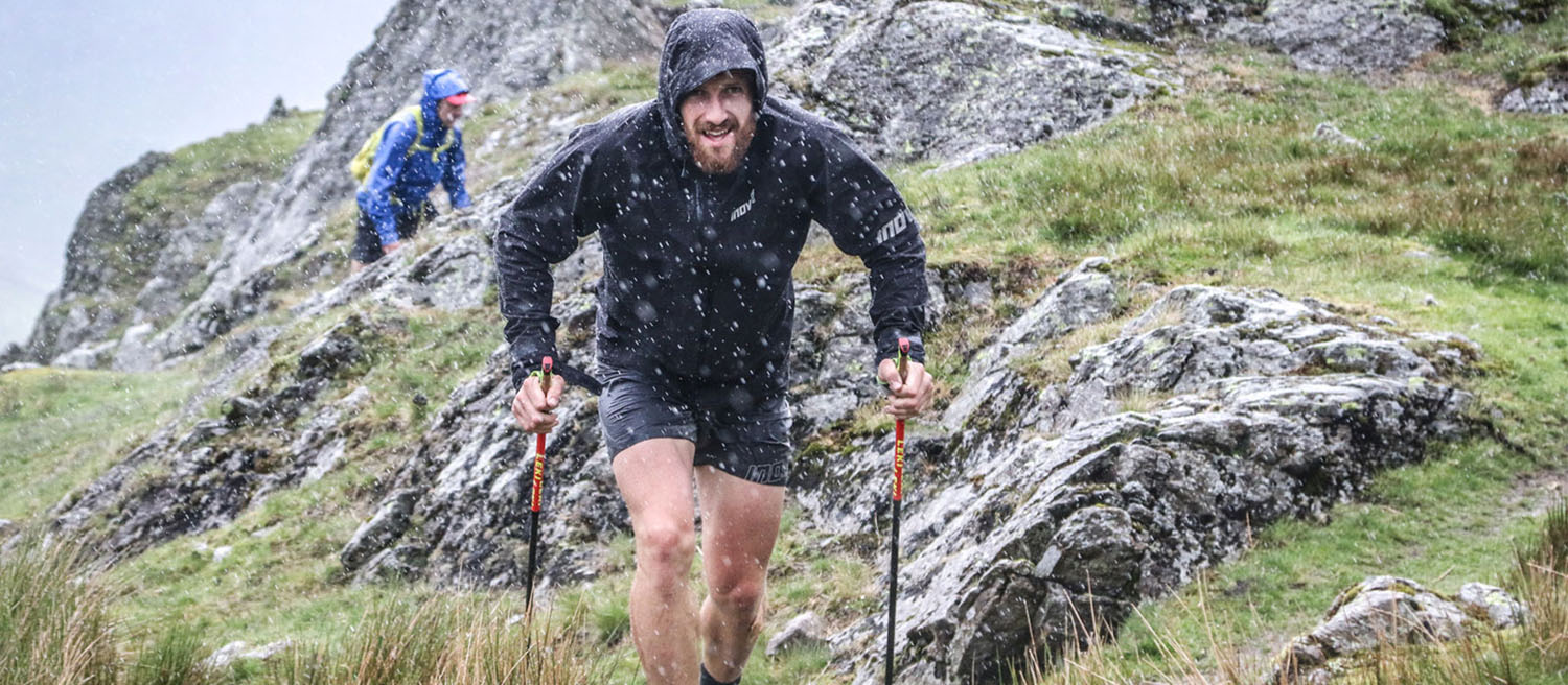 Athlete Paul Tierney in the hills using running poles