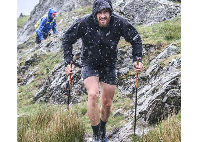 Athlete Paul Tierney in the hills using running poles