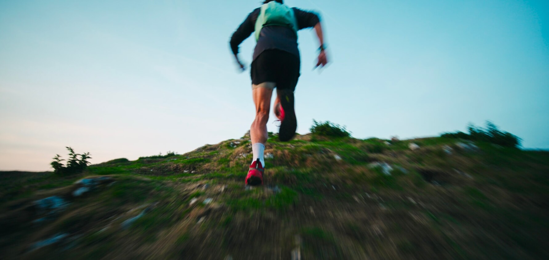 Ultra runner Tommy Lewis running up a hill