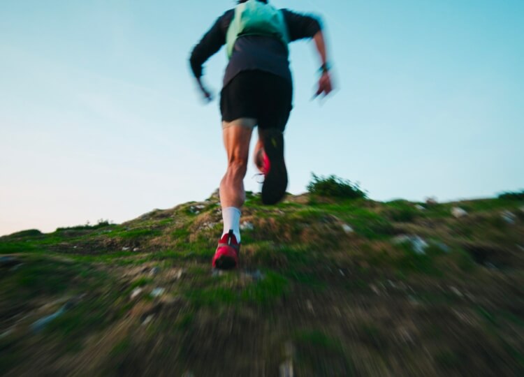 Ultra runner Tommy Lewis running up a hill