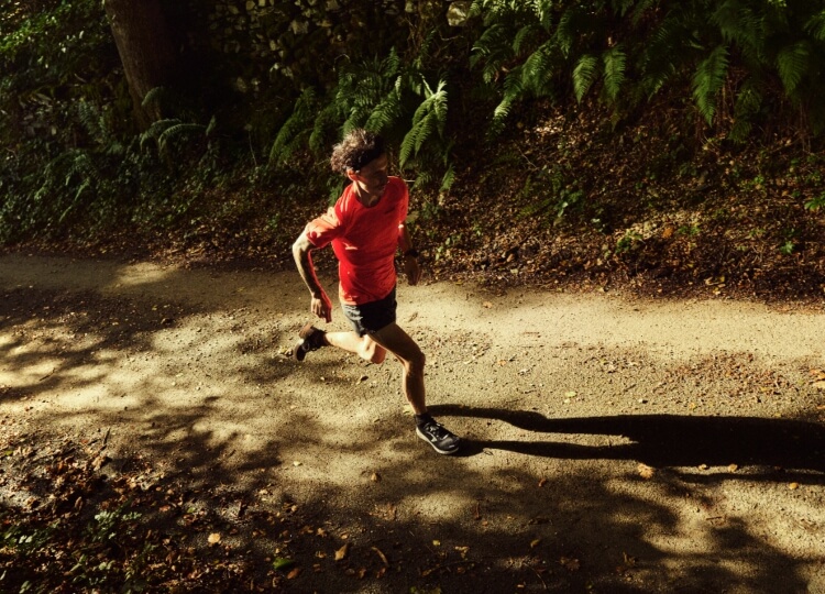 Man running on a dusty track