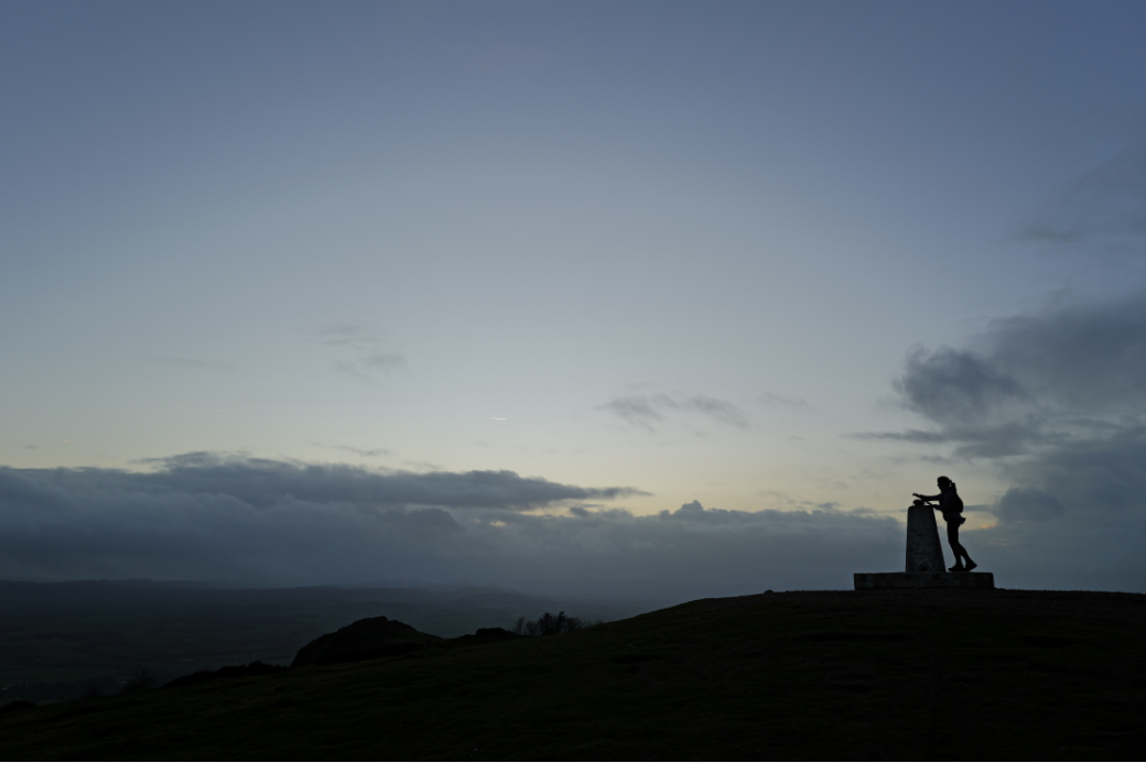 Sarah Perry touching the trig point during last light.