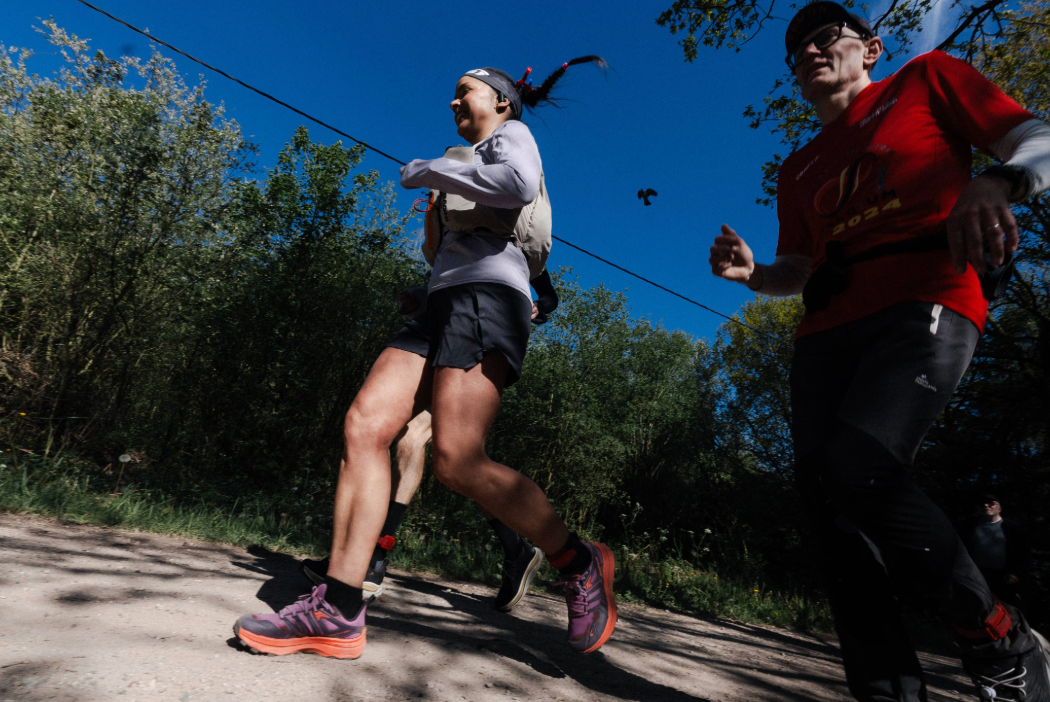 INOV8 Athlete Sarah Perry running with blue skies behind her, wearing the TRAILTALON MAX