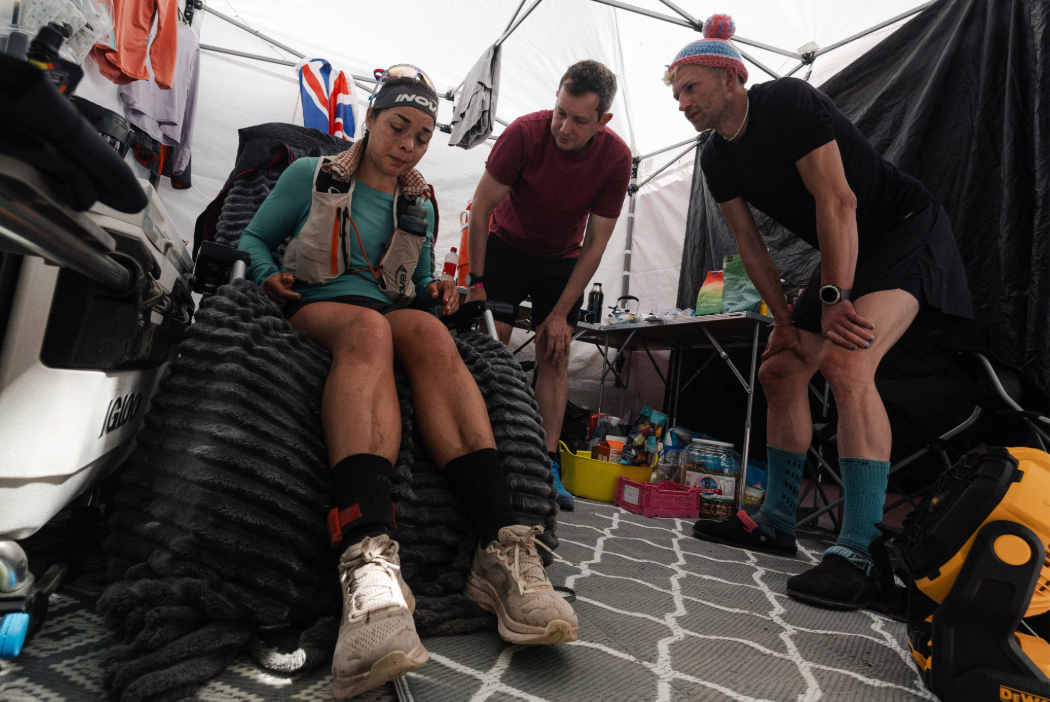 INOV8 Athlete Sarah Perry in her rest tent, surrounded by support.
