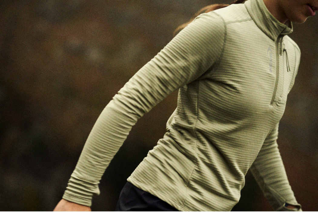 Hiker wearing the Adventure Mid Half Zip midlayer