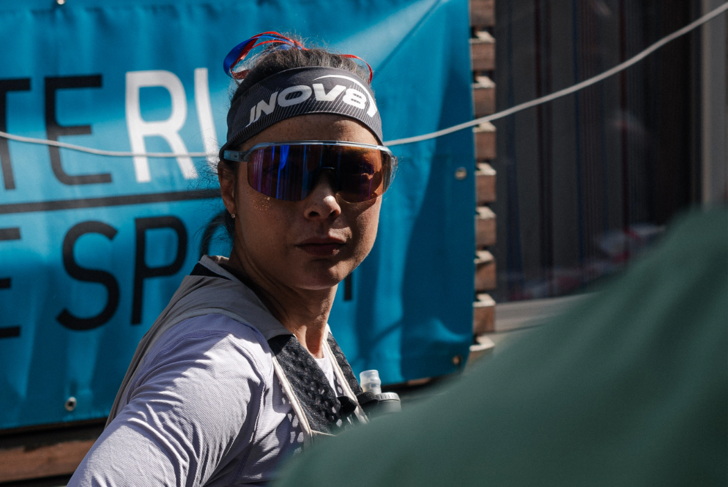 INOV8 Athlete Sarah Perry focused at the start line, looking towards the camera.