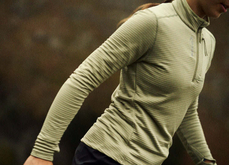Hiker wearing the Adventure Mid Half Zip midlayer