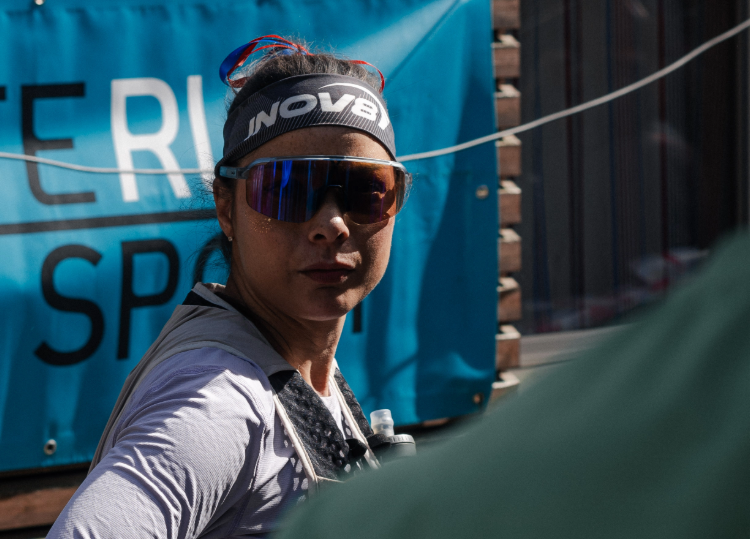 INOV8 Athlete Sarah Perry focused at the start line, looking towards the camera.