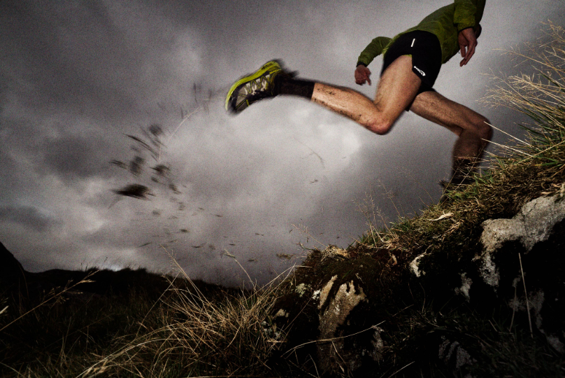 INOV8 Athlete running fast up a muddy fell