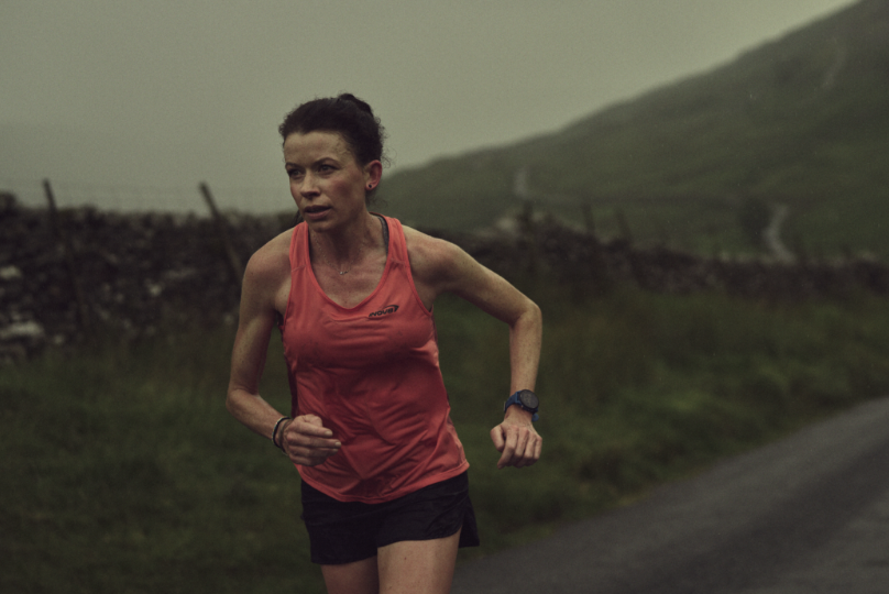 Sarah McCormack running on a road in the rain