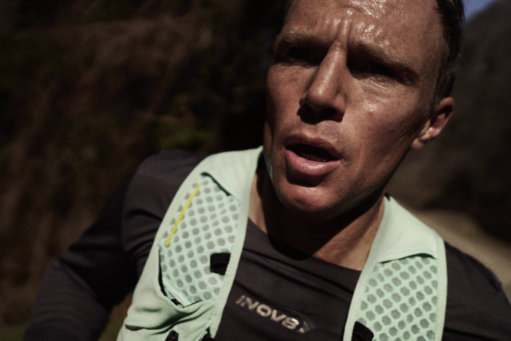 Close up of INOV8 Athlete Yannick Noel running and breathing hard.