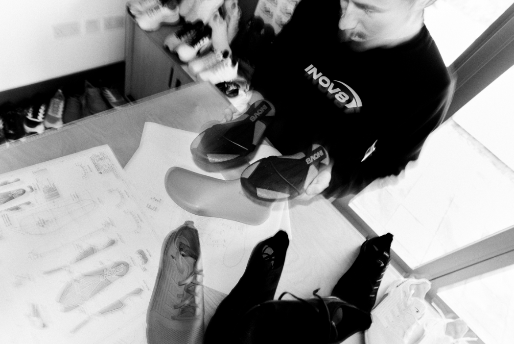 Comparing two outsoles of the new BARE-XF PRO, with draft technical drawings on a table below